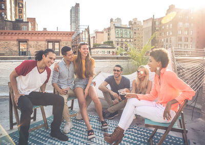 Happy friends on building terrace