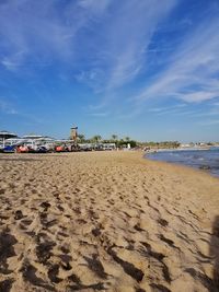 Scenic view of beach against blue sky