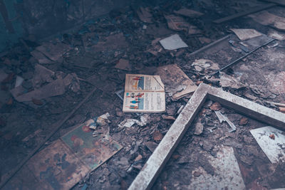 High angle view of old damaged book in abandoned room
