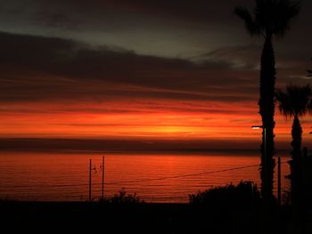 Scenic view of sea against orange sky