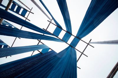 Low angle view of modern building against blue sky