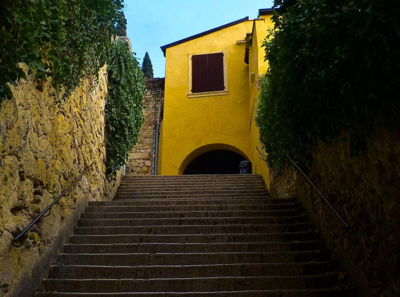 LOW ANGLE VIEW OF STEPS AND YELLOW BUILDING