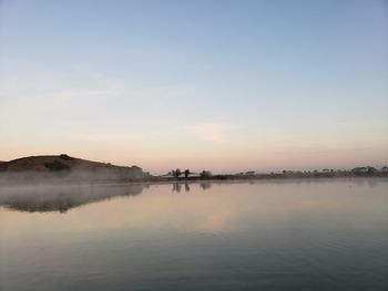 Scenic view of lake against sky during sunset