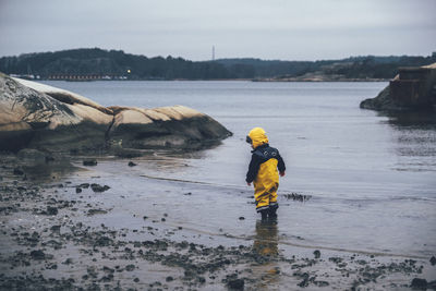 Child standing at sea