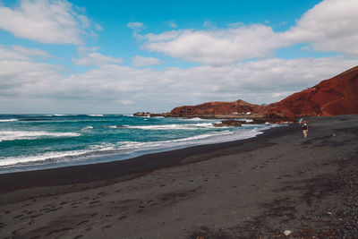 Scenic view of sea against cloudy sky