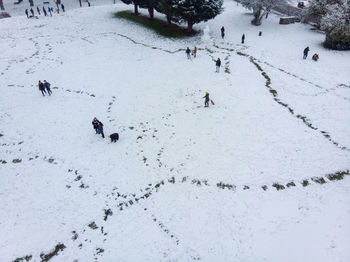 High angle view of people on snow covered field