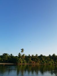 Scenic view of lake against clear blue sky