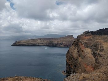 Scenic view of sea and mountains against sky