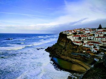 Scenic view of sea and buildings against sky