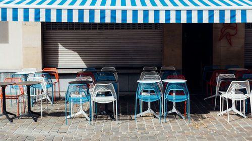 Empty chairs and tables against wall. empty chairs and tables on a bistro 