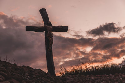 Low angle view of cross against sky during sunset