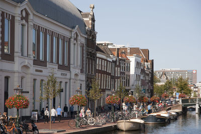 Group of people against buildings in city