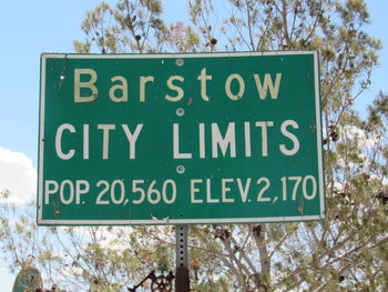 Low angle view of road sign against sky