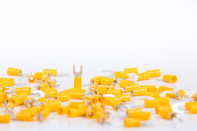 Close-up of yellow arranged on table against white background