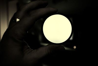 Close-up of human hand holding light bulb