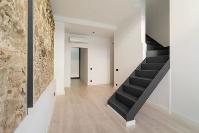 Refurbished apartment with restored ancient wall left from old city buildings. 