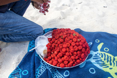 Low section of person with strawberries in plate