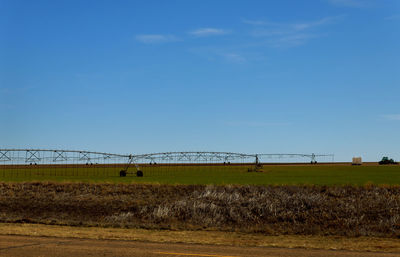 Scenic view of field against blue sky