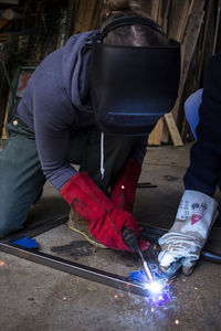 Low section of man working in workshop