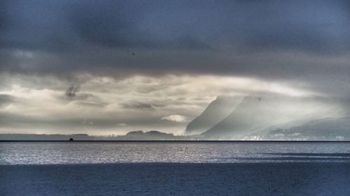 Scenic view of sea against cloudy sky