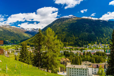 Scenic view of trees and buildings against sky