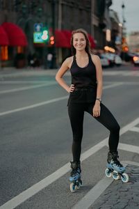 Portrait of smiling young woman on road in city