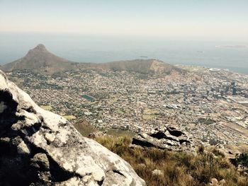High angle view of sea and mountains against sky