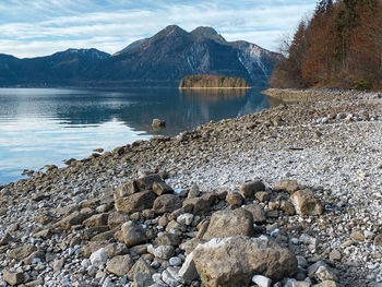 Scenic view of little island on lake walchensee  against mountains and  sky