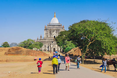 People walking in front of historical building