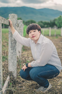 Portrait of man sitting on land