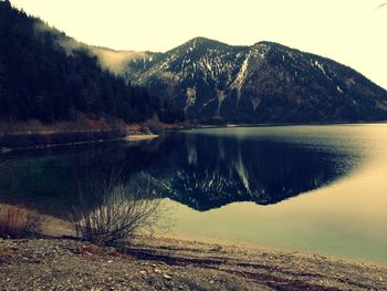 Scenic view of lake and mountains against clear sky