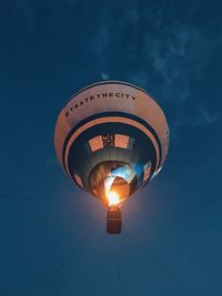 Low angle view of illuminated blue sky