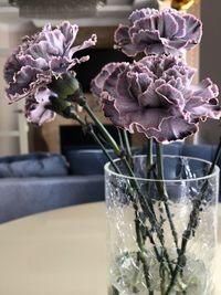 Close-up of purple flower vase on table