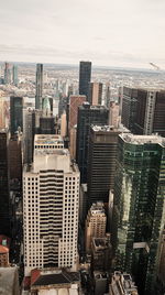 Aerial view of buildings in city against sky