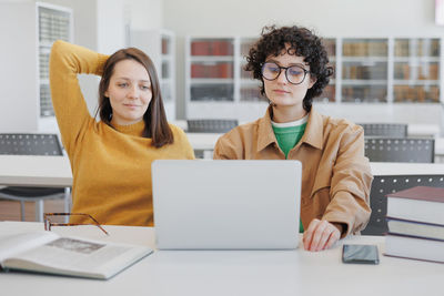 Businesswoman using laptop at desk in office
