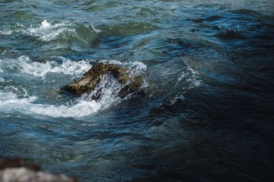 High angle view of water flowing through rocks