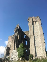 Low angle view of old building against blue sky