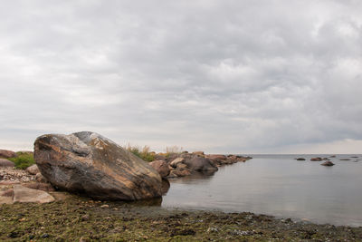 Rocks in sea against sky