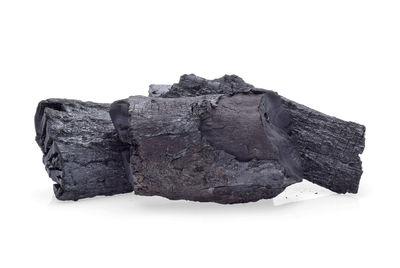 Close-up of bread on rock against white background