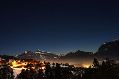 Scenic view of mountains against sky at night