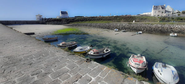 High angle view of boats moored in lake against buildings