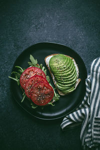 High angle view of avocado on toasted bread in plate