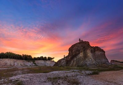 Silhouette of rock formations against sky during sunset