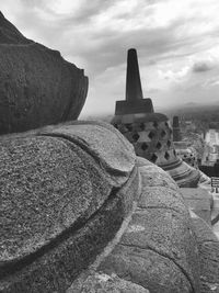 Ancient structure against cloudy sky