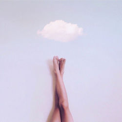 Low section of woman legs against white background