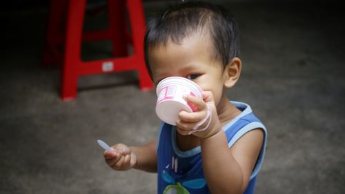 High angle view of cute boy holding ice cream