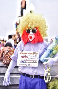 Midsection of man wearing sunglasses standing outdoors