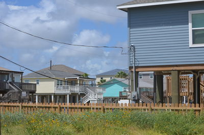 Houses on field against sky