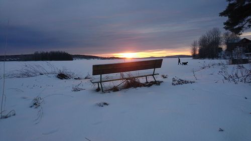 Scenic view of snow covered landscape against sky during sunset