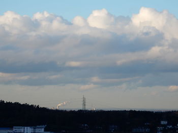 Low angle view of silhouette electricity pylon against sky